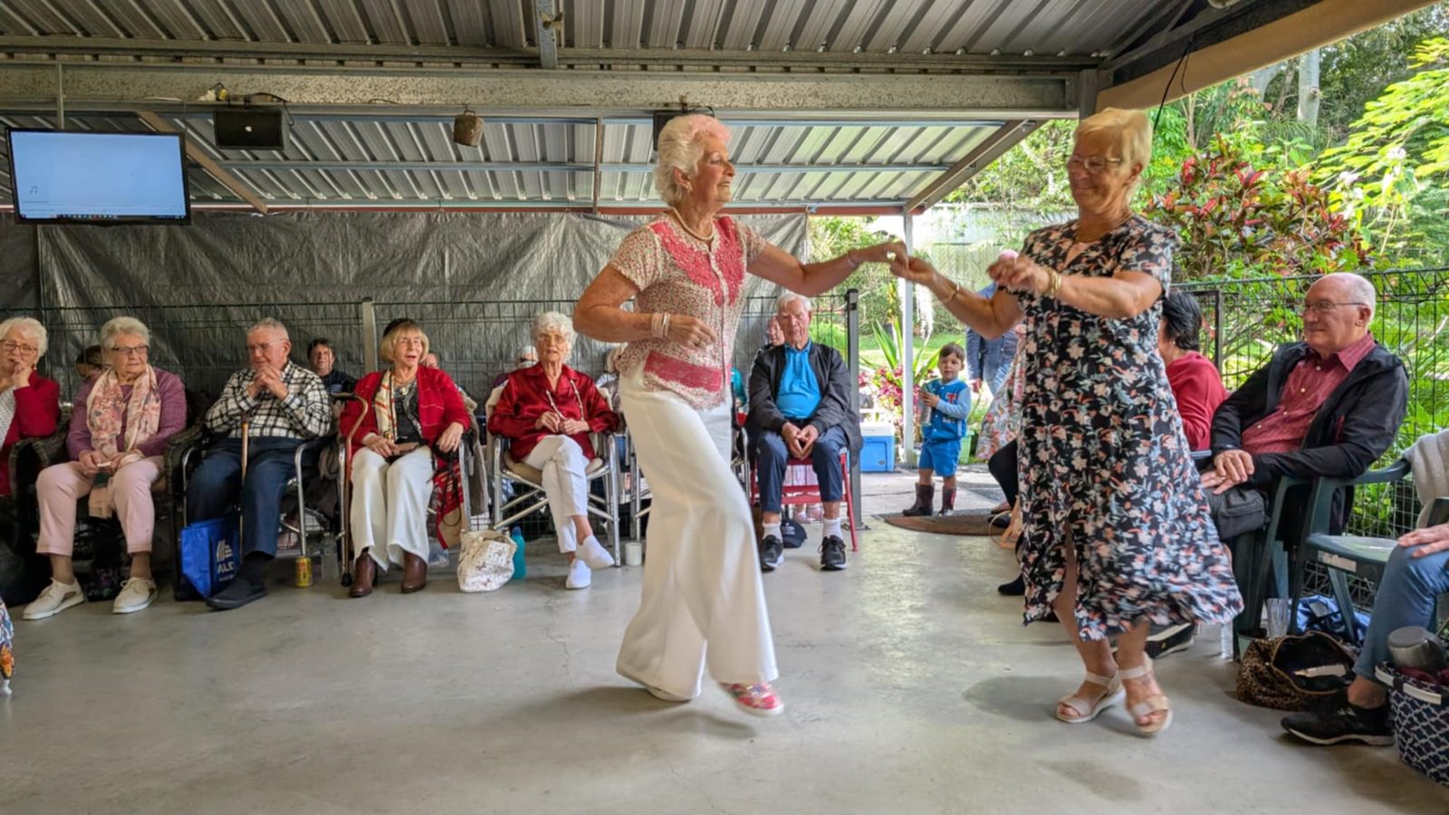 Older adults dancing together at a community music afternoon